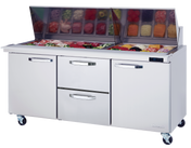 A commercial stainless steel sandwich prep table on wheels features a mega top glass section displaying chopped vegetables, with three closed compartments below: two side doors and a pull-out center drawer, perfect for efficient commercial refrigeration.