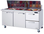 A stainless steel refrigerated prep table with two doors and two drawers on wheels. The top features an open section with containers of sliced vegetables, meats, and cheeses under a raised glass lid. A digital temperature display is on the right side.