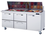 A stainless steel Mega Top Sandwich Prep Table with a glass lid open, revealing neatly arranged containers of sliced meats, vegetables, and cheeses. Below the prep area are three pull-out drawers and a door, all on wheels for mobility.