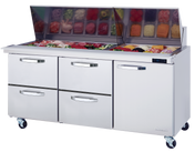 A stainless steel Mega Top Sandwich Prep Table with a glass lid open, revealing neatly arranged containers of sliced meats, vegetables, and cheeses. Below the prep area are three pull-out drawers and a door, all on wheels for mobility.