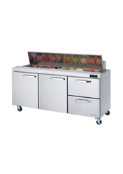 A three-section stainless steel sandwich prep table with two doors and two drawers on wheels, featuring a refrigerated prep table top with an open ingredient station. Various diced vegetables and toppings sit in clear containers beneath a glass sneeze guard.