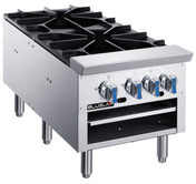 A commercial stainless steel gas stove for any commercial kitchen, featuring four black cast iron gas burners, four blue and silver control knobs, sturdy metal legs, the BLUEFLAME logo on the front, and an open shelf below the knobs. Plain white background.