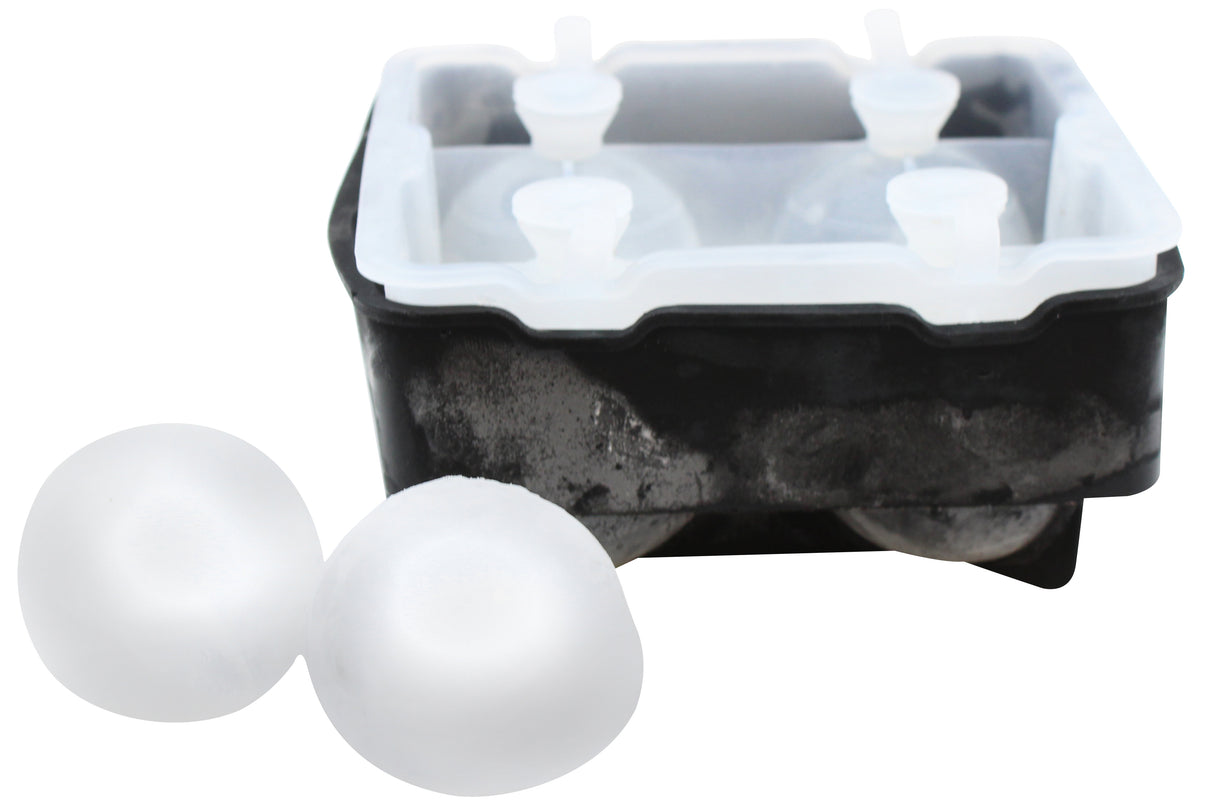 A black silicone ice tray with a transparent lid is shown, with two smooth, clear ice spheres beside it. The mold appears partially frosted from recent use, demonstrating its effectiveness as an ice sphere tray for perfect round ice balls.