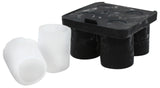 A black silicone shot glass ice tray with four cylindrical compartments sits on a white background. Two hollow, tube-like ice cubes made from the shot glass mold are displayed in front, demonstrating their unique shape.