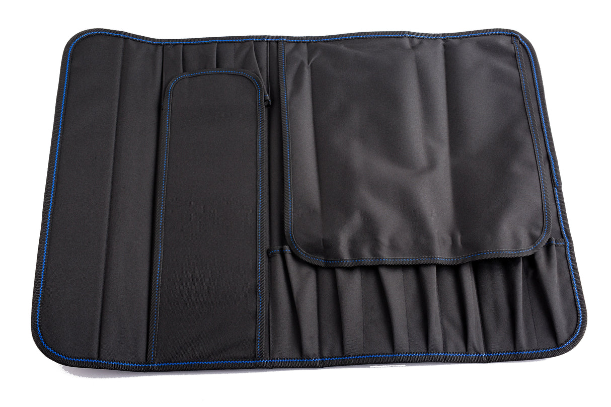A black ballistic nylon tool roll with blue stitching is laid flat. Designed as a knife case, it holds 10 knives in dedicated slots, features a zippered pocket on the left, and a large flap that covers its compartments and structure.