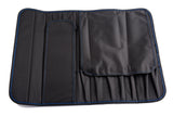 A black ballistic nylon tool roll with blue stitching is laid flat. Designed as a knife case, it holds 10 knives in dedicated slots, features a zippered pocket on the left, and a large flap that covers its compartments and structure.
