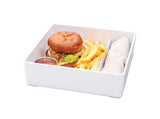 A white melamine tray holds a hamburger with lettuce, French fries, a small metal container of ketchup, and a rolled beige napkin, all arranged neatly on a white background and conveniently dishwasher safe.
