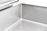 Close-up of the inside corner of a shiny, stainless steel tilting braising pan, showing smooth, reflective metal surfaces and welded seams. The top left features a metal handle. Perfect for multifunction cooking units with a 40 gallon capacity.