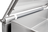 Close-up of a stainless steel tilting braising pan, focusing on the hinge and edge of a large rectangular container with a partially open lid. Smooth metal surfaces, visible welds, and rivets give this 40 gallon capacity unit a modern, industrial look.
