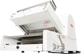 The Berkel MB1/2STD Bread Slicer features a white exterior, open top lid, and closely spaced metal blades. This countertop unit has a metal handle, “START” label on the side, plus product branding and caution labels on the front and top.