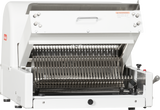 A Berkel countertop bread slicer with a white exterior, open front, and visible metal slicing blades arranged vertically. The top lid is raised, exposing the interior. Controls and warning labels are present on the machine’s side.