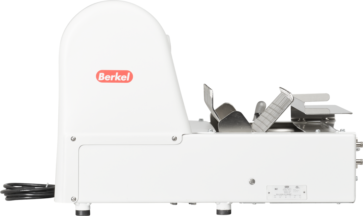 A side view of a white Berkel electric food slicer sits on a countertop, its power cord visible at the back. The slicer features a metal carriage, blade guard, adjustment knobs, and the red Berkel logo on its main housing.