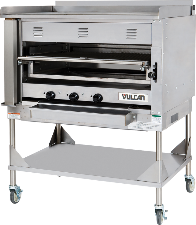 A large commercial stainless steel oven with three control knobs, vented front, and a pull-down door features the Vulcan logo. This Heavy Duty Chophouse Broiler sits on a metal stand with a lower shelf and four caster wheels for mobility.