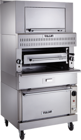 A large, stainless steel Vulcan V Series Deck-Broiler on wheels features single-deck infrared burners, a pull-down broiler door, vented grill area with adjustable rack, control knobs on each side, and a bottom oven compartment with handle and temperature control.