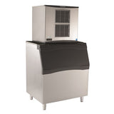 The Scotsman ice machine C1030SA-32A is a commercial ice maker featuring a large black front bin on four metal legs. Its industrial design includes an upper ice-making unit with air vents and a spacious lower bin for storing and dispensing ice.