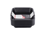 A stack of black rectangular Cash & Carry Grande Baskets with slotted sides, viewed from the front. Inside the top dishwasher safe basket is a white label with red and black text and graphics. The background is plain white.