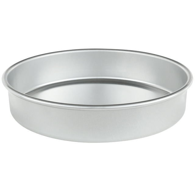 A silver, round aluminum cake pan (9 x 2) with straight sides and a flat bottom is shown on a white background. The empty pan is photographed at a slight angle, showcasing its depth and smooth, reflective surface.