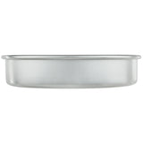 A round, shallow aluminum cake pan measuring 9 x 2 is shown from the side against a white background. The pan has straight edges, a smooth finish, and a slightly rolled rim around the top.