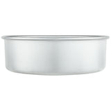 A plain, round, shallow 9 inch cake pan with a smooth surface and slightly flared rim is shown against a white background. The aluminum cake pan is empty and appears clean, with no designs or markings visible.