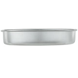 A plain, round, shallow aluminum cake pan is shown against a white background. The pan has smooth sides, a slightly outward-flared rim, and a matte silver finish. It appears empty and clean, with no handles or noticeable markings. Chef approved.