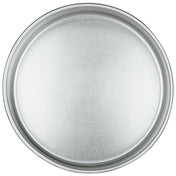 A round, chef-approved aluminum cake pan with a slightly raised rim, seen from above. The pan features a smooth, matte finish and a clean, empty surface that reflects soft light.