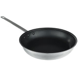 A 12 inch fry pan with a black non-stick interior and a long, straight silver handle featuring a hole at the end for hanging. The pan is empty and angled to show both the inside and part of the bottom surface.
