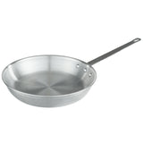 A 12 inch stainless steel Fry Pan with a wide, shallow base and slightly sloped sides. It features a long metal handle attached with three rivets and a small hole for hanging, while its surface is smooth and reflective.