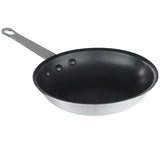 A 7 inch non stick fry pan with a smooth black interior and a silver metallic exterior. It features a flat base, gently sloped sides, and a long metal handle with a hole for hanging, securely fastened by three rivets.