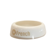 A small, round, white bowl by TableCraft Products with a wide base and short sides. The words Lite French are printed on the side in tan and gray letters. The empty bowl is set against a plain white background.