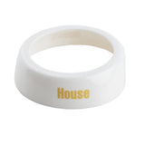 A glossy white, rounded ring-shaped ceramic napkin holder by TableCraft features the word House in bold yellow letters on the side. Its smooth, reflective surface and plain white interior add a modern touch to your table setting.