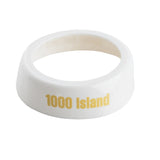 A white, oval-shaped plastic Dispenser ID Collar with "1000 Island" printed in yellow on the side. The TableCraft CB8 ring has a smooth, glossy finish and a hollow center, perfect as a label or identifier for condiment containers.