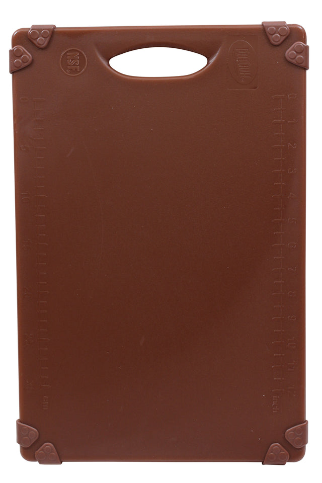 A brown rectangular grippy cutting board with a handle at the top. Raised measurement markings in centimeters run along the left and right edges. The four corners are reinforced with triangular grips. The smooth surface is unmarked and dishwasher safe.