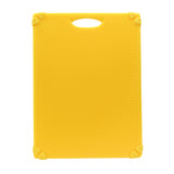 A bright yellow rectangular grippy cutting board with a built-in handle hole at the top. Each corner features a small, heart-shaped grip for stability. Measurement markings are faintly visible along the left and right edges. Dishwasher safe cutting board.