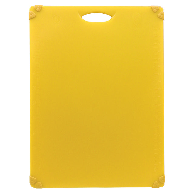 A rectangular yellow anti-slip cutting board with rounded corners and a handle cutout at the top. The board features rubber grips on each corner and faint measurement markings along the edges. The background is plain white.