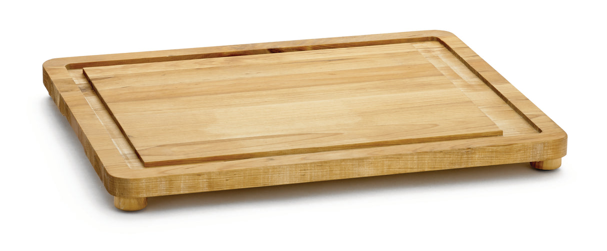 A rectangular wooden carving board with rounded edges and short legs. The board has a groove near the edge to catch liquids, a light wood grain, and non-slip feet. The background is plain white.