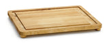 A rectangular wooden carving board with rounded edges and short legs. The board has a groove near the edge to catch liquids, a light wood grain, and non-slip feet. The background is plain white.