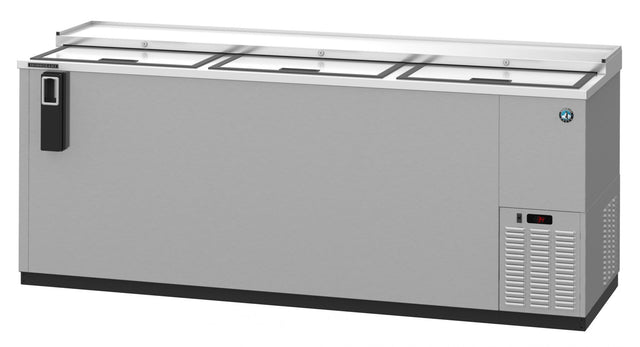 A large, stainless steel refrigerated bottle cooler with three sliding glass lids on top, a black handle on the left side, self-contained refrigeration vented on the right, and a small digital temperature display showing “38°.”.