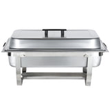 A full size stainless steel rectangular chafing dish with a lid and black handles, supported by a sturdy folding frame. Perfect for serving hot food at buffets or events, the image shows this chafing dish from the front.