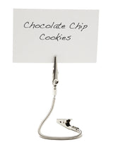 A white card with “Chocolate Chip Cookies” handwritten in black sits clipped upright by a steel double sided Number/Card Holder featuring a flexible, coiled stem, against a plain white background.
