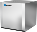 A stainless steel Ice-O-Matic modular cube ice maker with a boxy, rectangular shape and a smooth, reflective surface. The blue and white company logo appears on the upper left corner. The commercial ice machine sits on a plain white background.