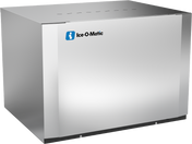 A large, rectangular stainless steel Modular Cube Ice Maker with a smooth front and sides, featuring the blue and white Ice-O-Matic logo on the upper left corner. This commercial ice maker offers a minimalist design and sits neatly on a flat surface.