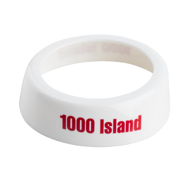 A glossy white Dispenser ID Collar with “1000 Island” in bold red letters. The ring-shaped TableCraft collar, smooth to the touch, fits around a bottle or dispenser, identifying its contents—perfect for organizing salad dressing containers.