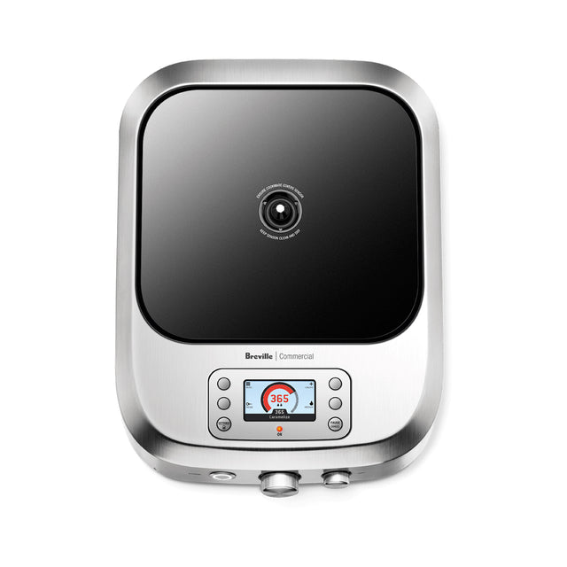A top-down view of the Breville Control Freak commercial induction stove with a black glass cooking surface. Below the cooktop, there’s a digital display showing 36.5°C and control buttons, all within a sleek stainless steel frame and rounded edges.