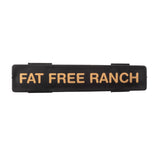 A black rectangular TableCraft object with gold text, perfect as a stylish name tag.