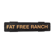 A black rectangular TableCraft object with gold text, perfect as a stylish name tag.