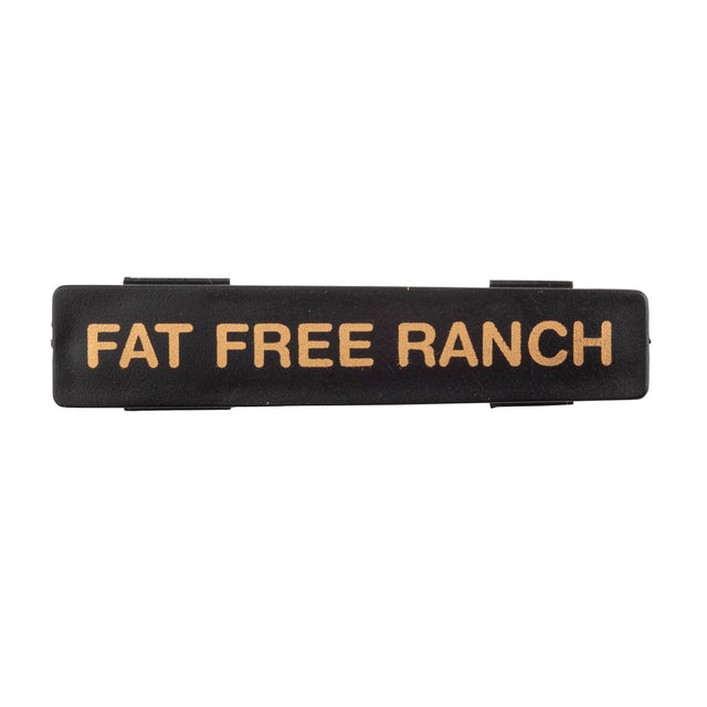 A black rectangular TableCraft object with gold text, perfect as a stylish name tag.