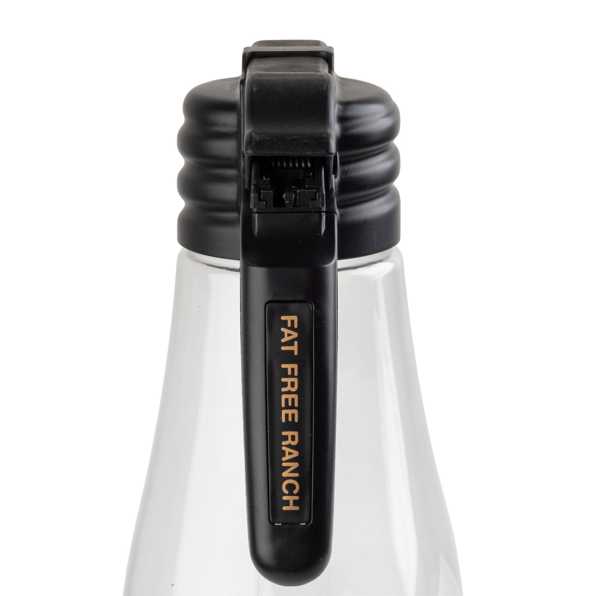 A close-up of a clear TableCraft bottle with a black flip-top cap. The cap features a vertical name tag that reads “FAT FREE RANCH” in gold letters on black. The white liquid inside suggests it contains fat free ranch salad dressing.