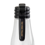A close-up of the neck and black cap of a clear TableCraft bottle, with “FAT FREE ITALIAN” printed in gold on the black flip-top lid’s handle. The ribbed cap and transparent bottle hint at salad dressing, like a labeled name tag for your table.