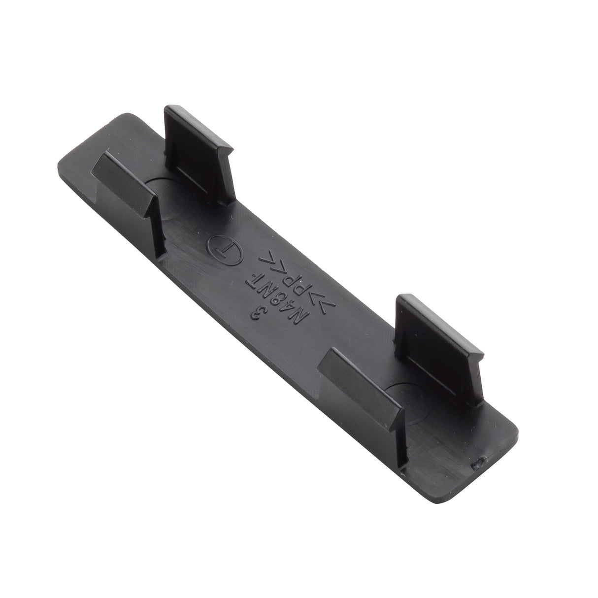 A rectangular black plastic clip with four upward-facing rectangular tabs—two on each long side—designed to secure a name tag or label. The surface features small embossed symbols and text, including arrows, letters, and numbers. Edges are smooth and slightly rounded.