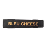A rectangular black plastic name tag with the words BLEU CHEESE printed in bold tan letters across the center, photographed on a plain white background—perfect for identifying a salad dressing dispenser.